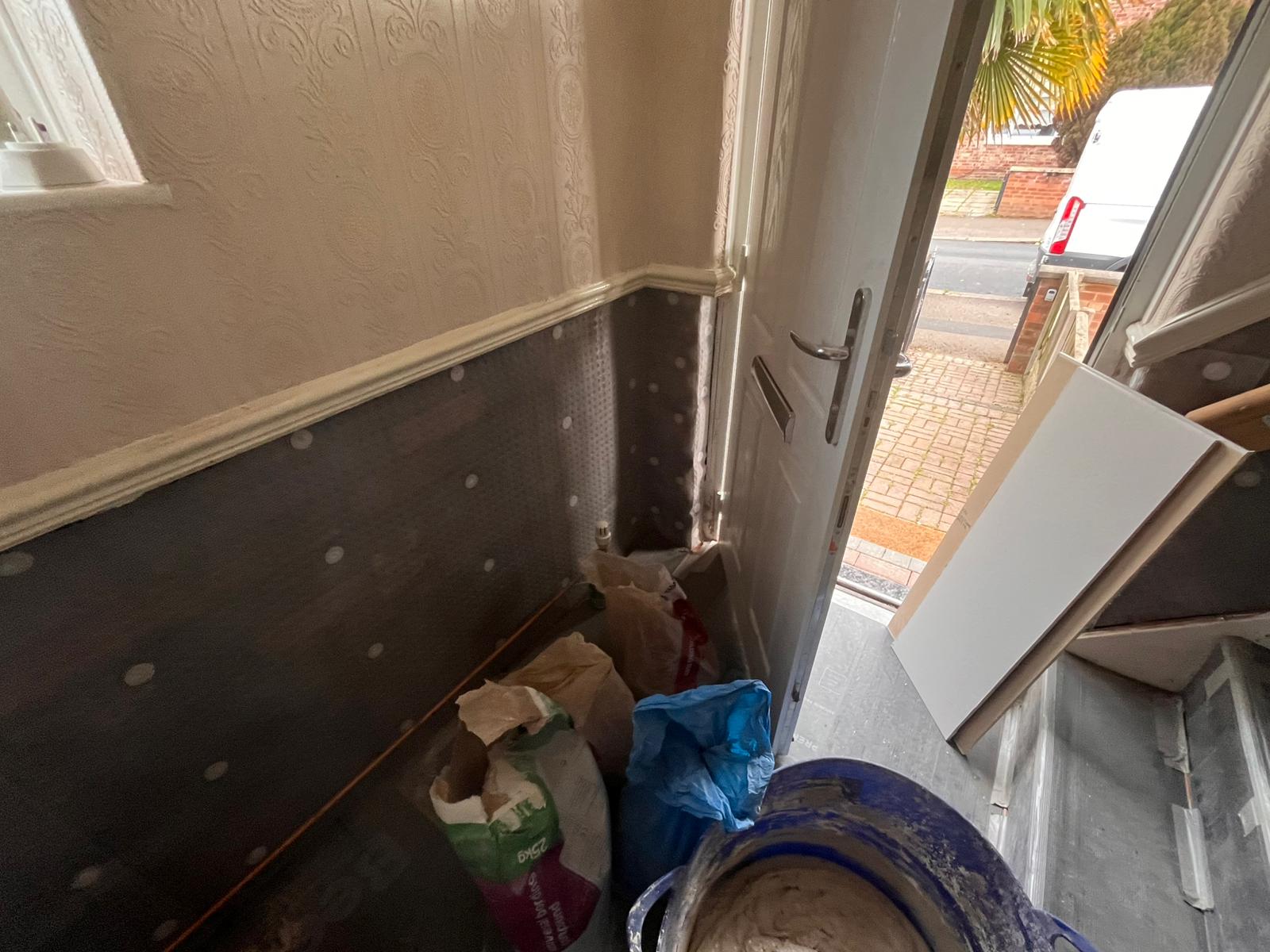 Hallway with anaglypta wallpaper above and damp-proof membrane below dado
