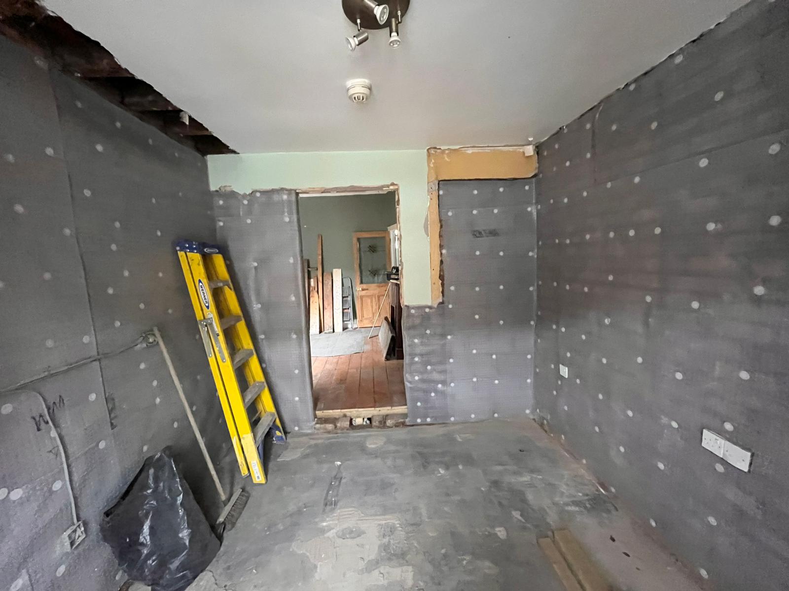 Living room being tanked with full damp-proof membrane on all walls
