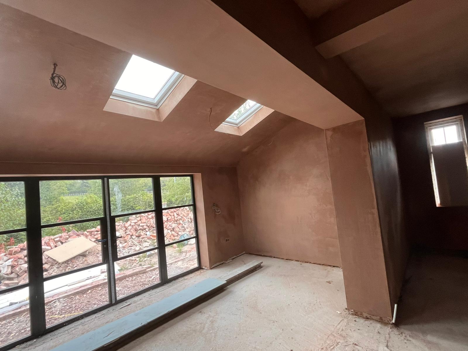 Loft conversion freshly skimmed with twin skylights and steel-framed bifold doors