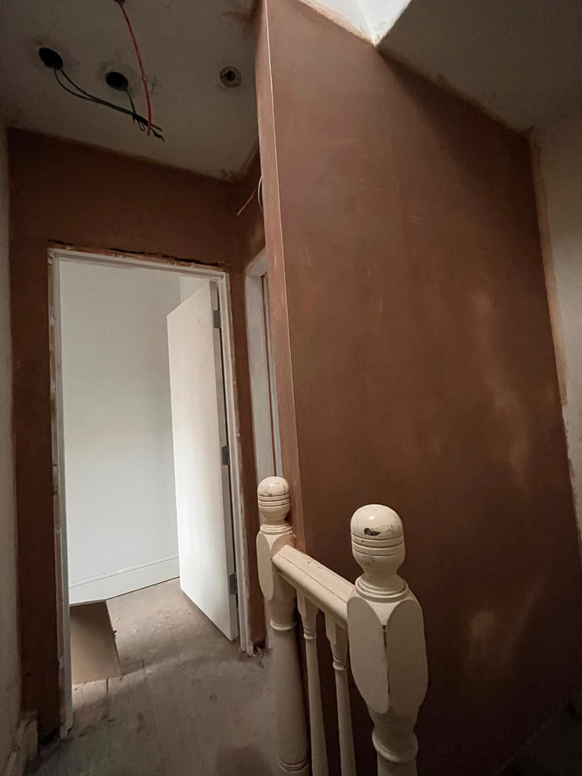 Landing freshly skimmed beside white painted newel post