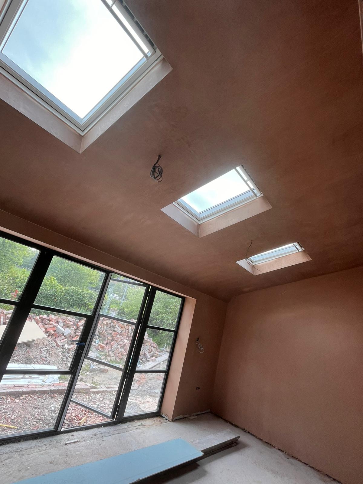 Pitched ceiling with two skylights and steel bifold doors freshly skimmed