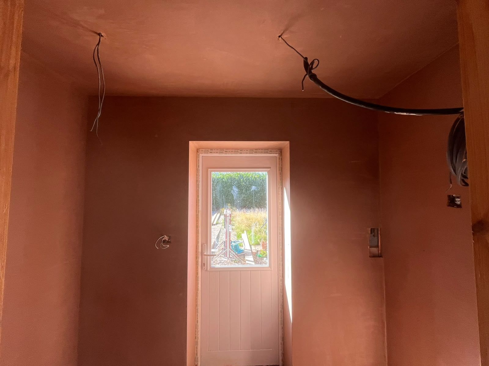 Back door lobby with walls and ceiling freshly skimmed