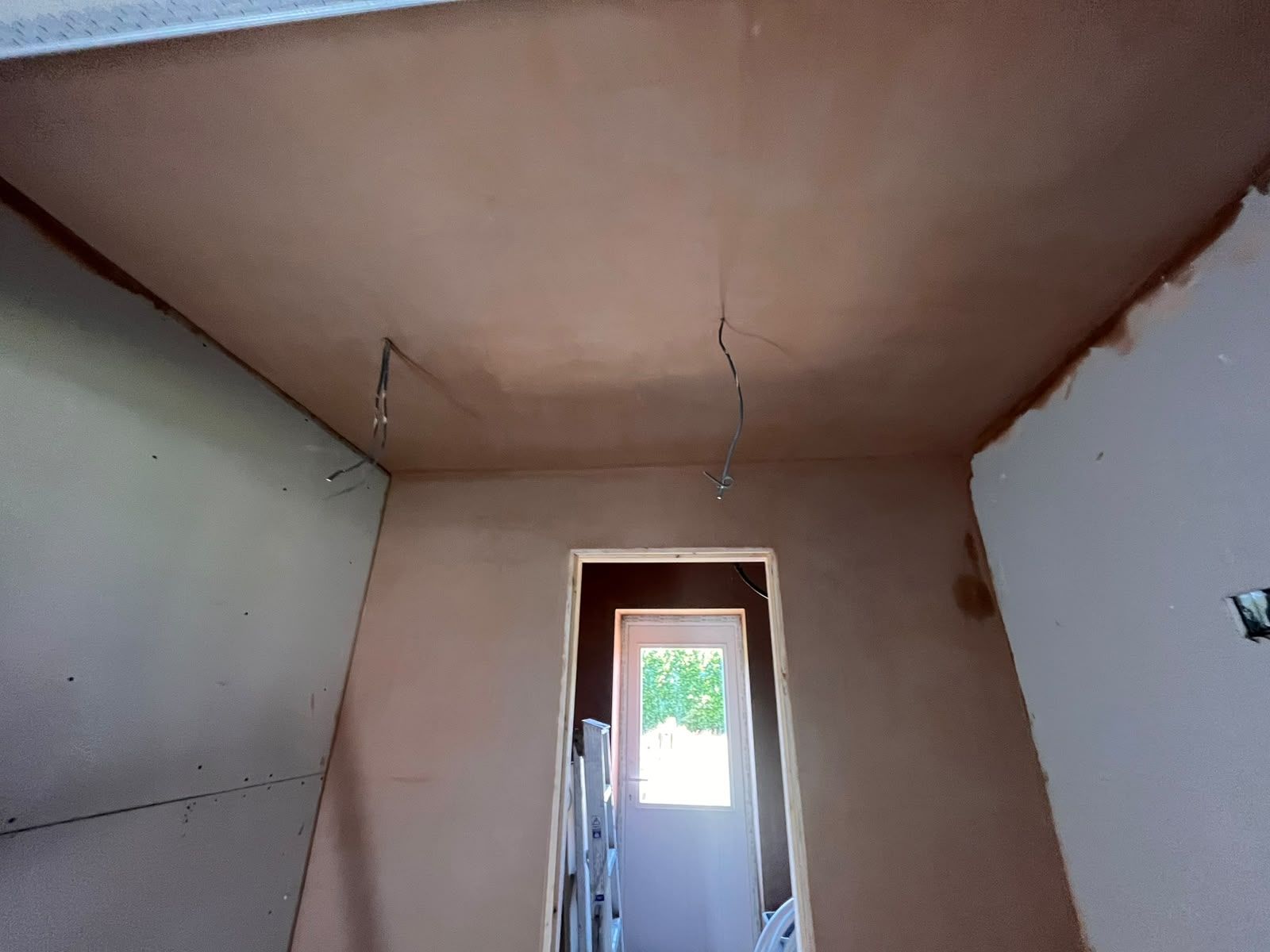 Long through-room skimmed wall to ceiling towards the rear door