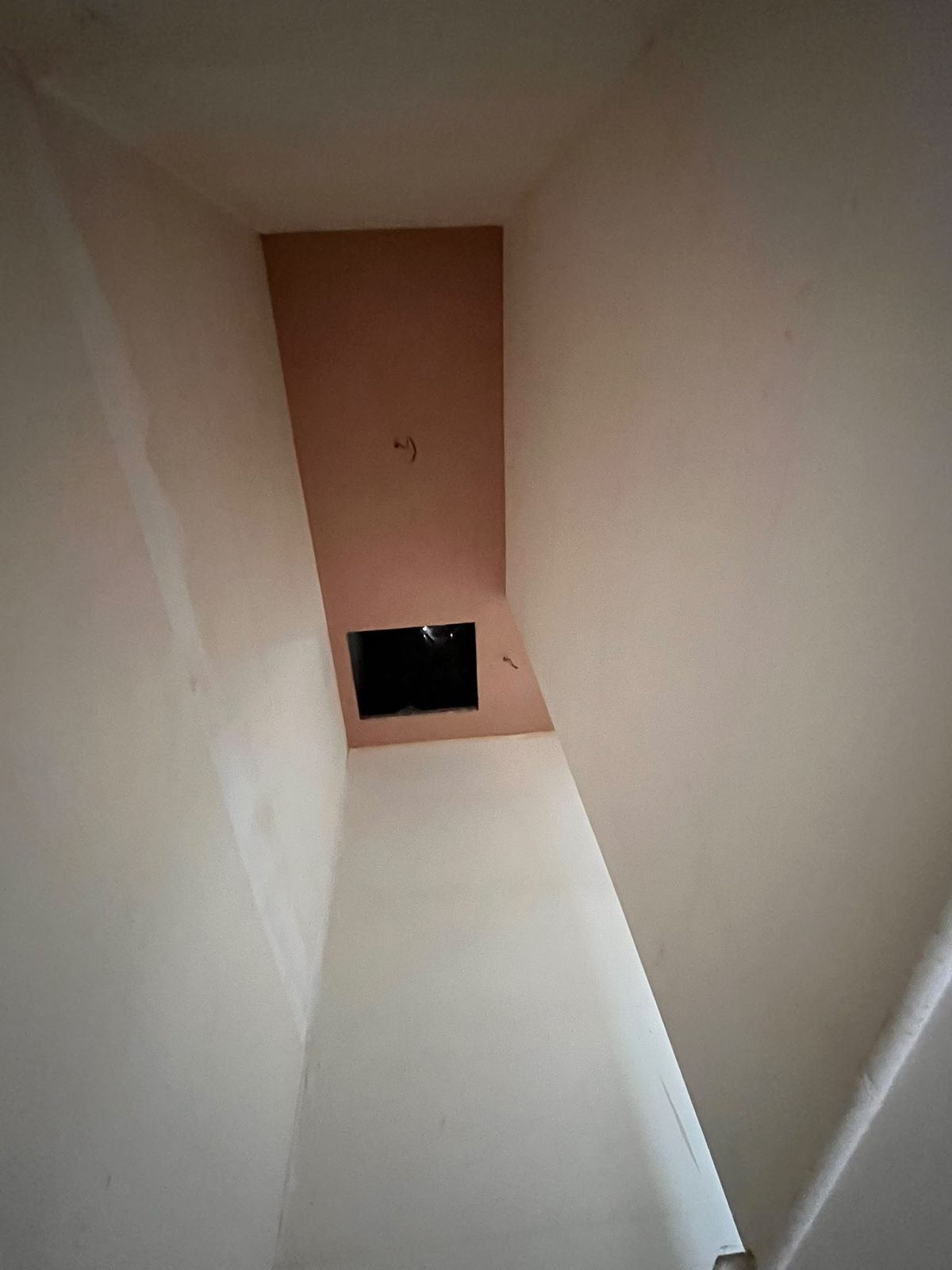 Stairwell walls and ceiling freshly skimmed up to the loft hatch
